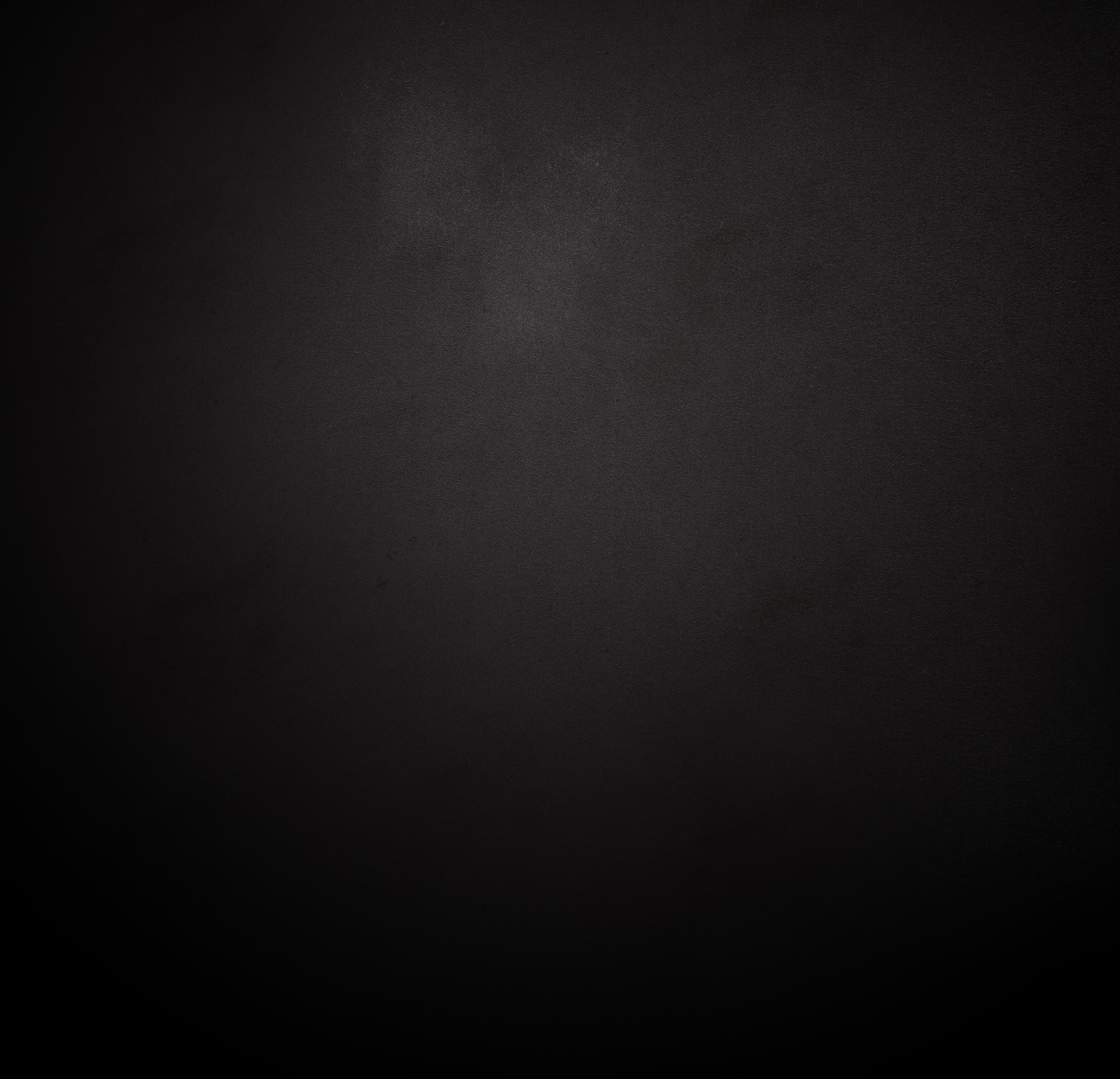 Dark textured backdrop with a faint gray highlight, quiet and atmospheric